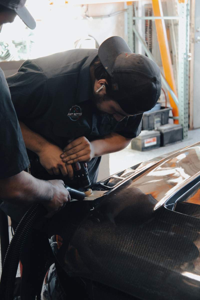 Technician working on a car's engine bay