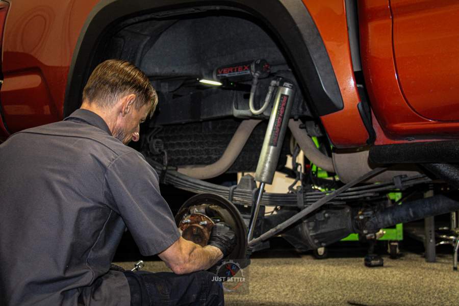 Mechanic working on a truck's suspension and brakes